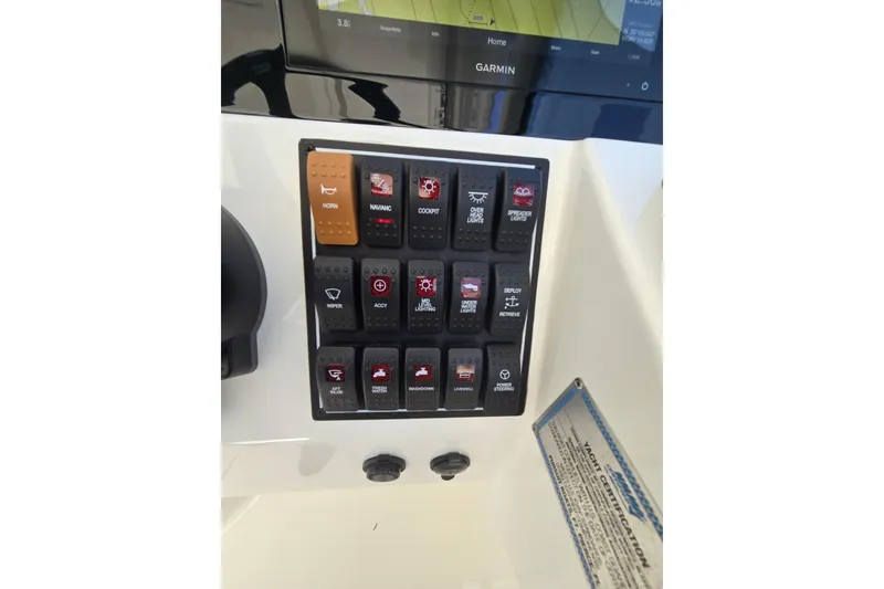 Slide: The Image of Control panel of a 2020 Pursuit DC 266 Dual Console boat with labeled switches. - 21