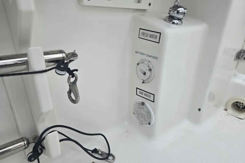 Slide: The Image of 2020 Pursuit DC 266 Dual Console boat deck with chrome fittings and hatch. - 25