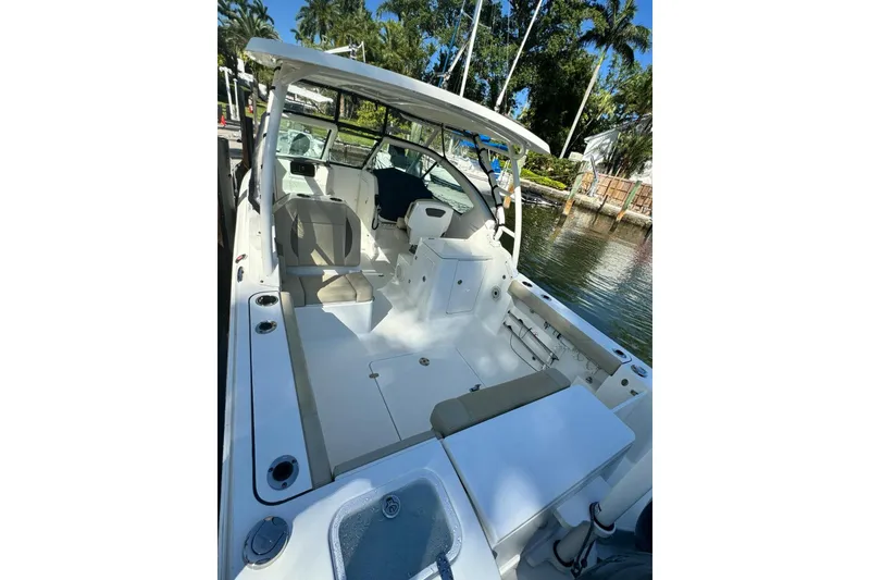 Slide: The Image of 2020 Pursuit DC 266 Dual Console storage compartment with open lid, showcasing interior details. - 28