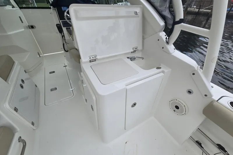 Slide: The Image of 2020 Pursuit DC 266 Dual Console boat on stands, showing motor and hull details. - 34