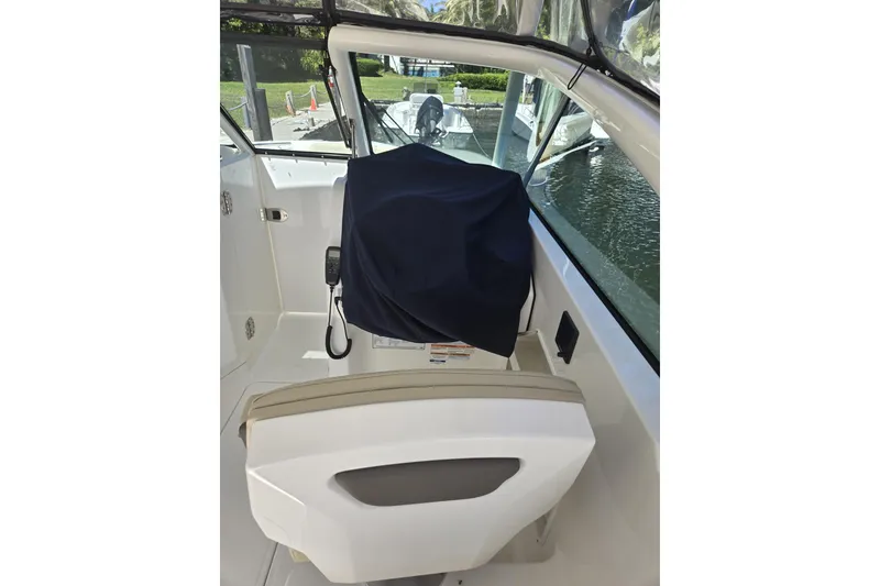 Slide: The Image of 2020 Pursuit DC 266 Dual Console boat hull on stands in a shipyard. - 40