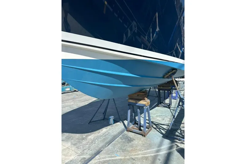 Slide: The Image of 2020 Pursuit DC 266 Dual Console boat docked by a wooden pier in a serene marina. - 50