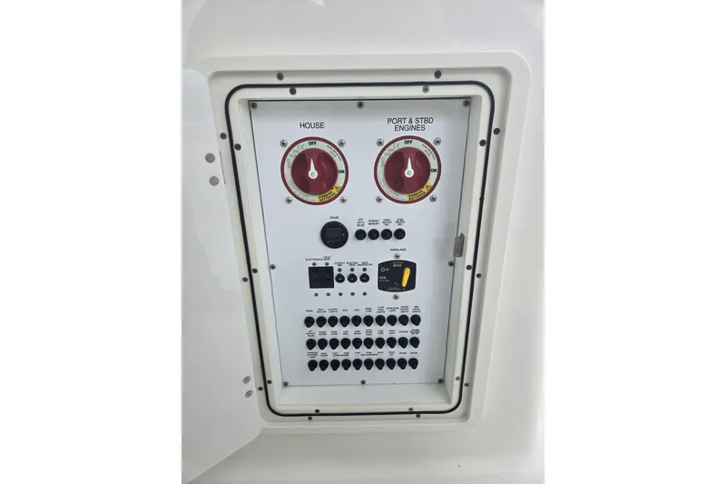 Slide: The Image of 2020 Pursuit DC 266 Dual Console boat docked near lush greenery and waterfront homes. - 8