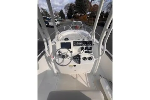 Slide: The Image of 2021 Boston Whaler 190 Montauk boat with cushioned seating, parked outdoors. - 4
