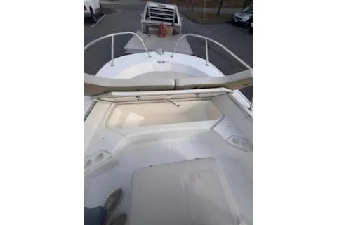 Slide: The Image of 2021 Boston Whaler 190 Montauk boat interior with engine and seating. - 9