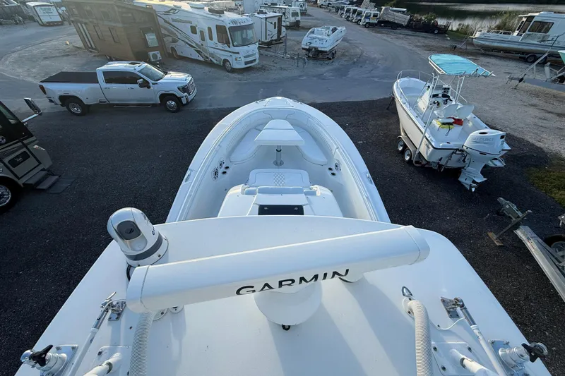 Slide: The Image of 2018 Edgewater 370CC boat with Garmin equipment, parked near RVs and other boats. - 26