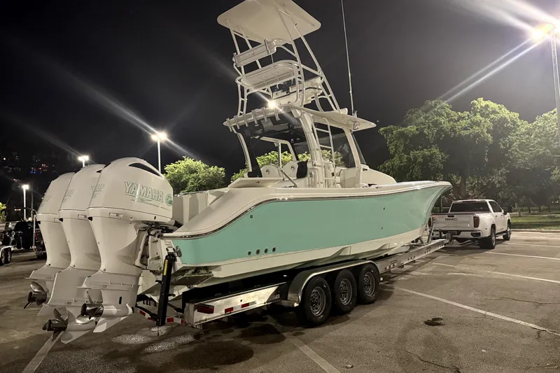 Slide: The Image of 2018 Edgewater 370CC boat on trailer at night, illuminated by streetlights. - 3