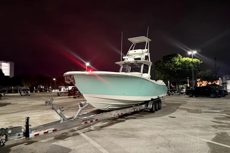 Slide: The Image of 2018 Edgewater 370CC boat on trailer, night scene with bright lights. - 5