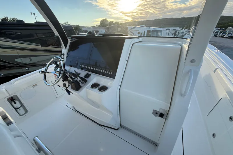 Slide: The Image of 2018 Edgewater 370CC boat with triple engines, surrounded by lush greenery. - 9