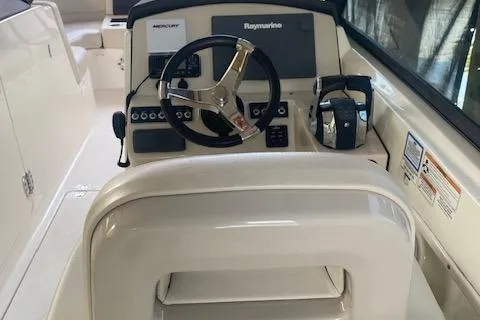 Slide: The Image of 2017 Boston Whaler 270 Vantage boat helm with steering wheel and control panel. - 12