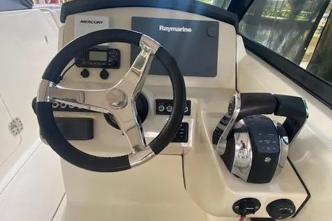 Slide: The Image of 2017 Boston Whaler 270 Vantage helm with steering wheel and control panel. - 14
