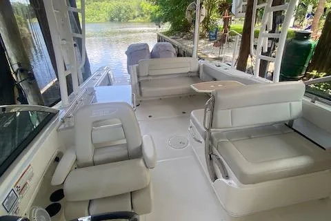 Slide: The Image of 2017 Boston Whaler 270 Vantage interior with seating, table, and water view. - 15