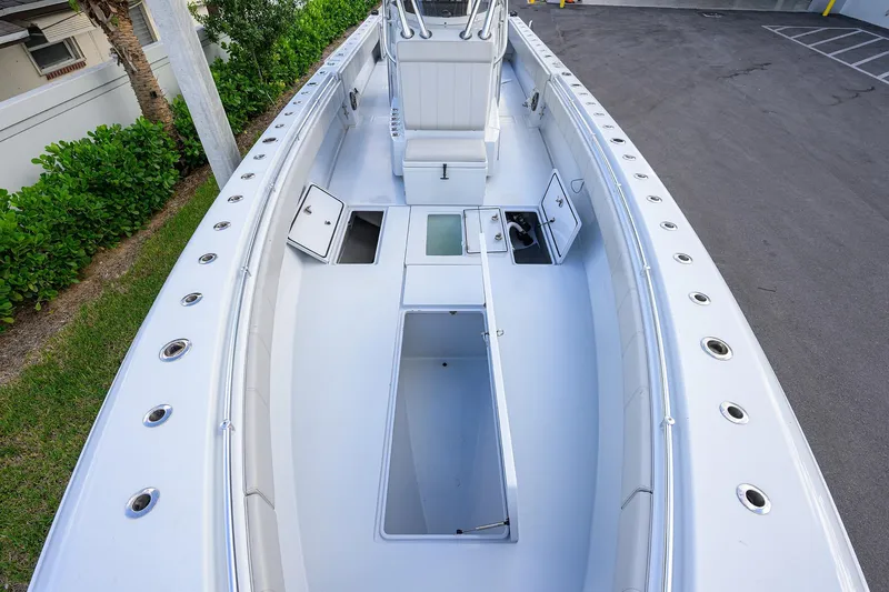 Slide: The Image of 2022 Contender 39 ST boat deck with open storage compartments and seating. - 10