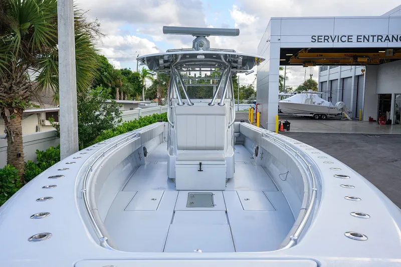 Slide: The Image of 2022 Contender 39 ST boat at service entrance, showcasing sleek design and spacious deck. - 11