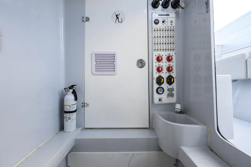 Slide: The Image of Control panel and fire extinguisher inside 2022 Contender 39 ST boat cabin. - 14