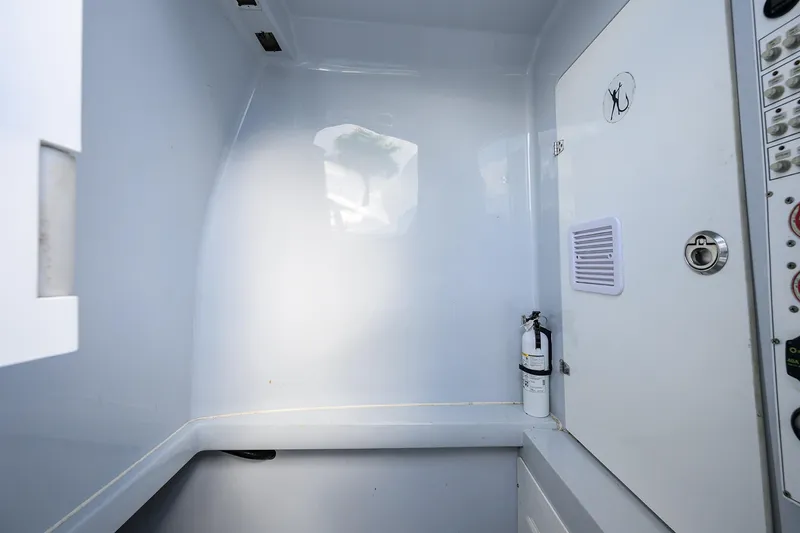 Slide: The Image of Interior of 2022 Contender 39 ST boat with fire extinguisher and control panel. - 15