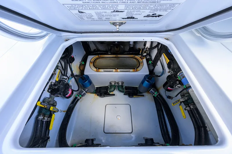 Slide: The Image of 2022 Contender 39 ST boat compartment with valves and hoses. - 16