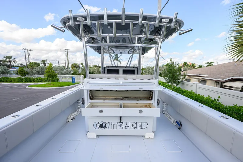 Slide: The Image of 2022 Contender 39 ST boat with open storage compartments, sleek design, and modern features. - 17