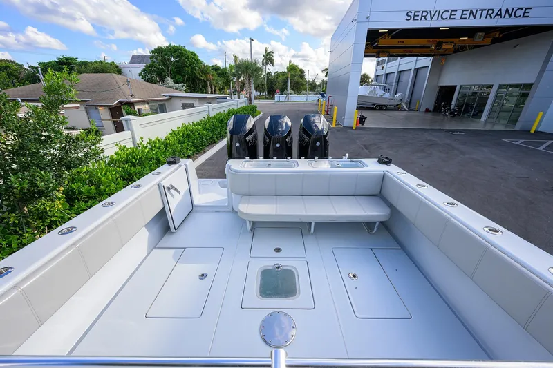 Slide: The Image of 2022 Contender 39 ST boat with triple engines at service entrance, showcasing spacious deck. - 22