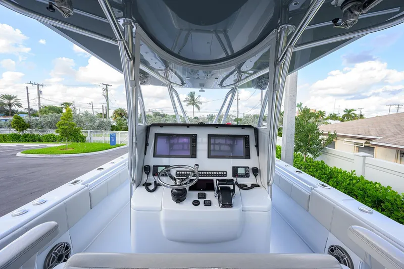 Slide: The Image of 2022 Contender 39 ST boat cockpit with modern navigation equipment and steering wheel. - 5