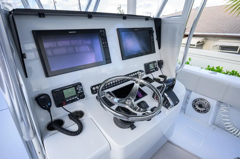 Slide: The Image of 2022 Contender 39 ST boat helm with dual Raymarine displays and modern controls. - 6