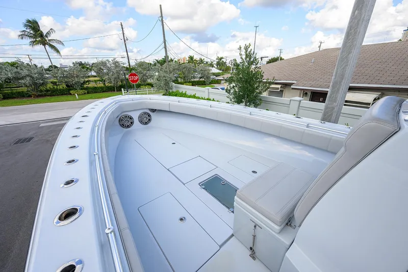Slide: The Image of 2022 Contender 39 ST boat deck with seating, speakers, and clear sky background. - 7