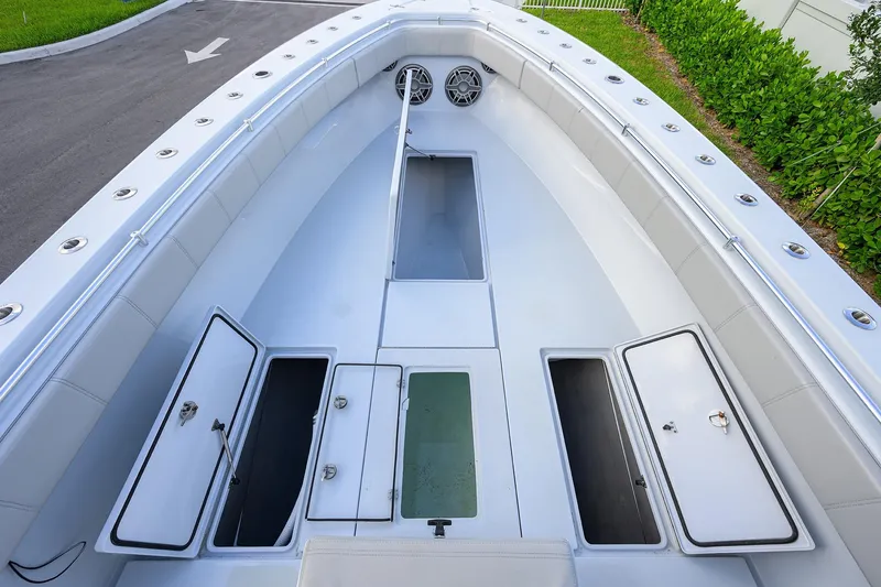 Slide: The Image of 2022 Contender 39 ST boat deck with open storage compartments and seating. - 8