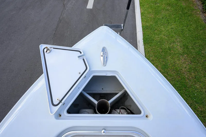 Slide: The Image of Bow of 2022 Contender 39 ST boat with open hatch, parked on road. - 9