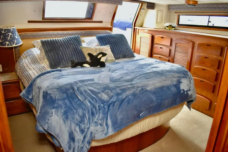 Slide: The Image of Luxurious bedroom interior of 1987 Californian 55 Cockpit Motor Yacht with blue bedding. - 15