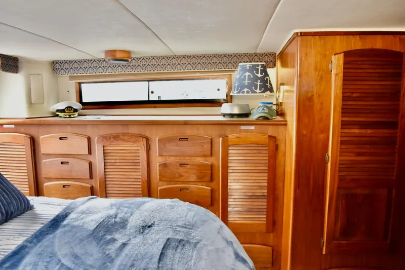Slide: The Image of Interior of 1987 Californian 55 Cockpit Motor Yacht with wooden cabinetry and nautical decor. - 19
