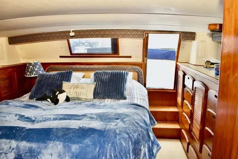 Slide: The Image of Luxurious bedroom interior of 1987 Californian 55 Cockpit Motor Yacht with plush bedding. - 20