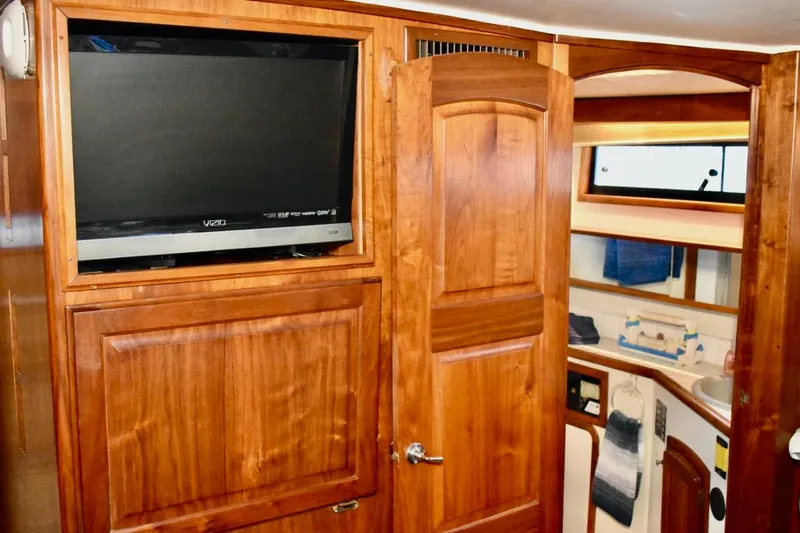 Slide: The Image of Interior of 1987 Californian 55 Cockpit Motor Yacht with wood paneling and TV. - 21