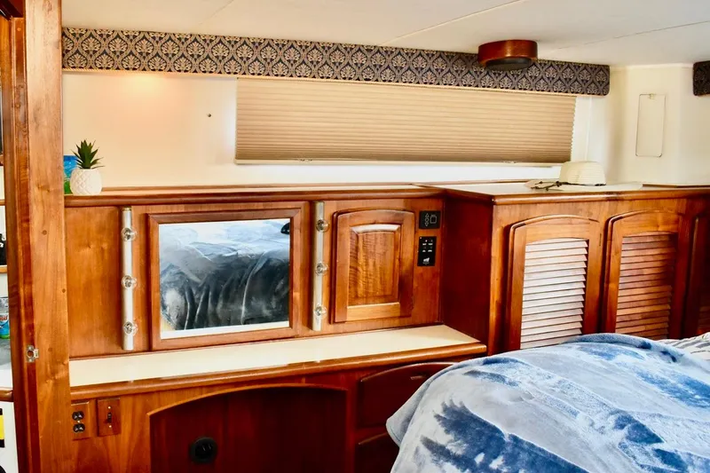 Slide: The Image of 1987 Californian 55 Cockpit Motor Yacht interior with wooden cabinetry and cozy decor. - 26