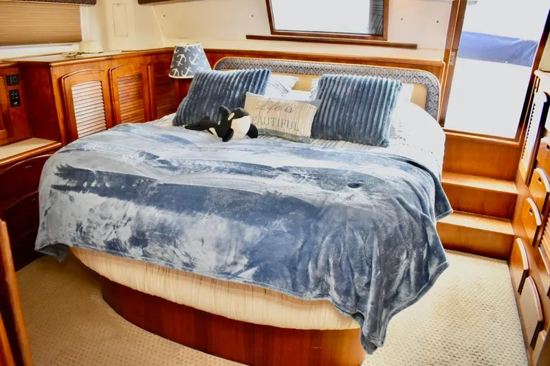 Slide: The Image of Luxurious bedroom interior of 1987 Californian 55 Cockpit Motor Yacht with plush bedding. - 27