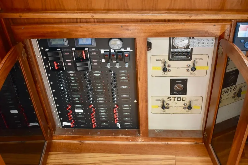 Slide: The Image of Electrical control panel of 1987 Californian 55 Cockpit Motor Yacht, featuring switches and gauges. - 28