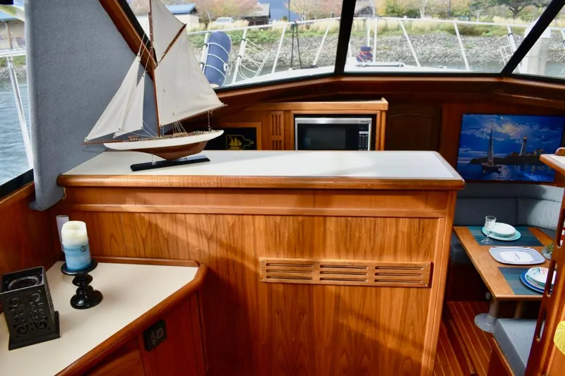 Slide: The Image of 1987 Californian 55 Cockpit Motor Yacht interior with wooden cabinetry and nautical decor. - 34