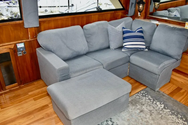 Slide: The Image of Gray sofa in 1987 Californian 55 Cockpit Motor Yacht interior with striped pillows. - 35
