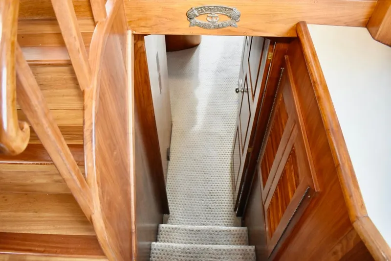 Slide: The Image of Staircase and hallway inside 1987 Californian 55 Cockpit Motor Yacht, featuring wooden finishes. - 37