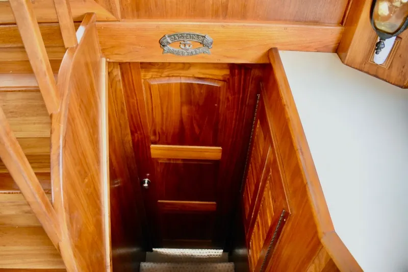 Slide: The Image of Wooden interior of 1987 Californian 55 Cockpit Motor Yacht, featuring stairs and door. - 40