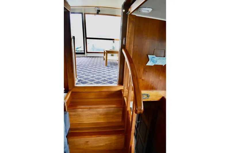 Slide: The Image of Interior of 1987 Californian 55 Cockpit Motor Yacht with wooden stairs and carpeted floor. - 42