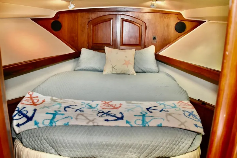Slide: The Image of Cozy cabin interior of 1987 Californian 55 Cockpit Motor Yacht with nautical-themed bedding. - 43