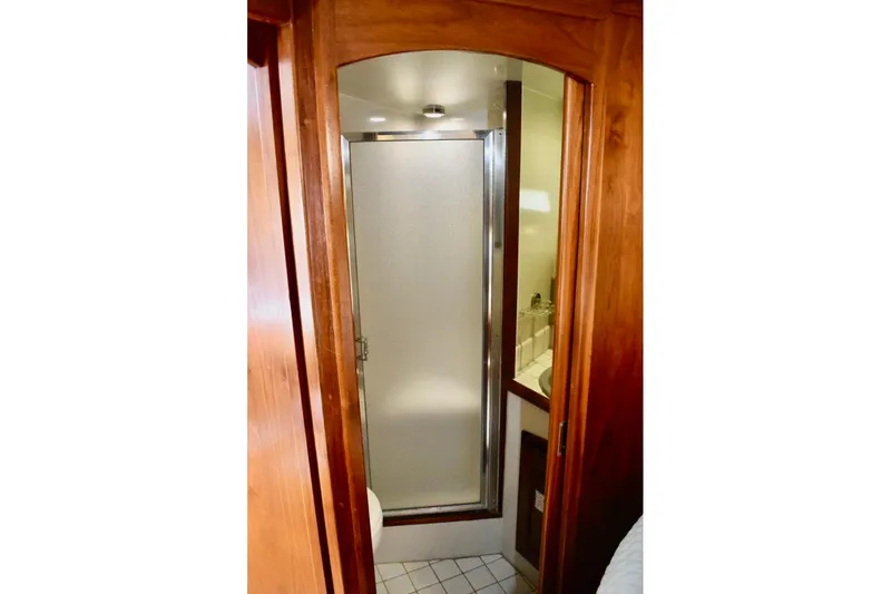 Slide: The Image of 1987 Californian 55 Cockpit Motor Yacht bathroom with wooden door and shower. - 45