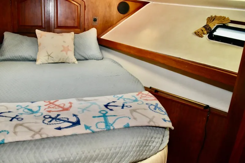 Slide: The Image of Cozy cabin interior of 1987 Californian 55 Cockpit Motor Yacht with nautical-themed bedding. - 46