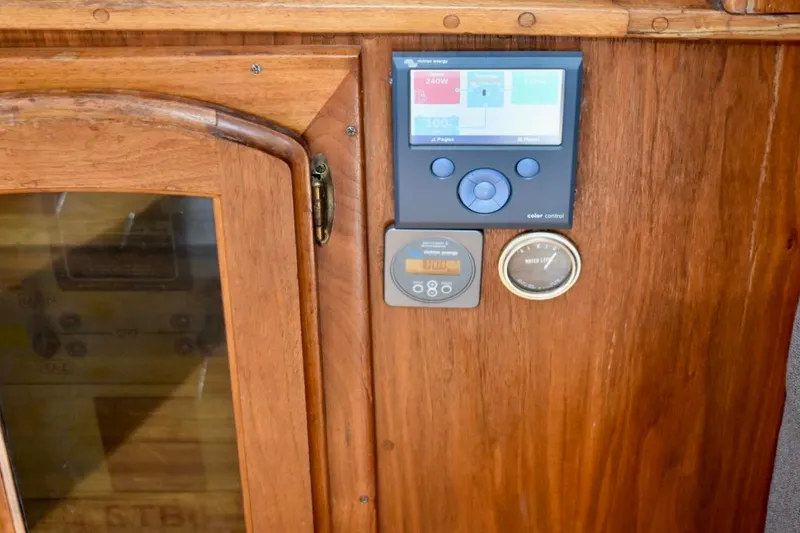 Slide: The Image of Control panel on 1987 Californian 55 Cockpit Motor Yacht, featuring wood finish and digital displays. - 48
