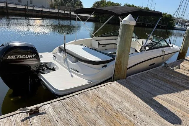 Slide: The Image of 2017 Sea Ray SPX 190 Outboard boat docked, featuring a Mercury engine and black canopy. - 11