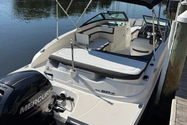 Slide: The Image of 2017 Sea Ray SPX 190 Outboard boat docked, featuring a Mercury engine and spacious seating. - 14