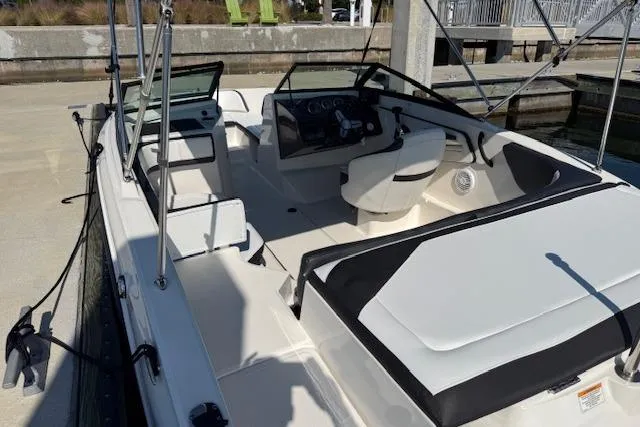 Slide: The Image of 2017 Sea Ray SPX 190 Outboard boat interior at dock, featuring seating and steering console. - 15