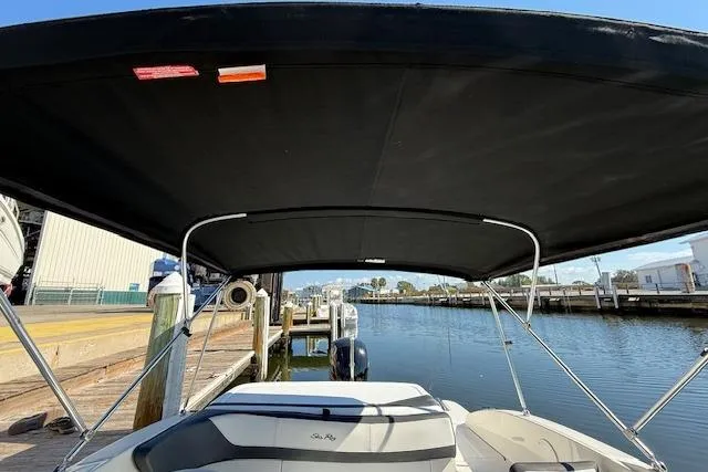 Slide: The Image of 2017 Sea Ray SPX 190 Outboard boat with canopy, docked at a marina. - 20