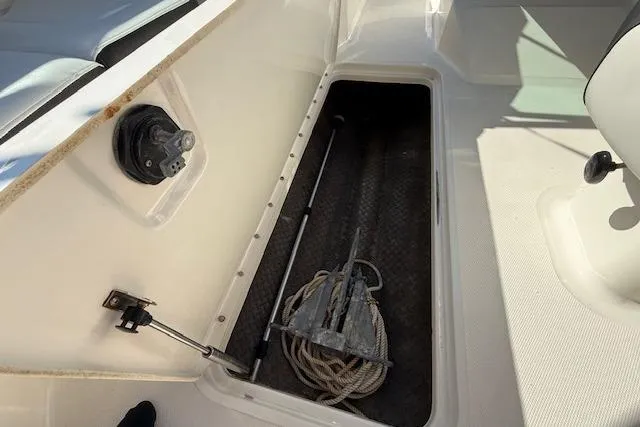 Slide: The Image of Storage compartment in a 2017 Sea Ray SPX 190 Outboard boat with anchor and rope. - 27