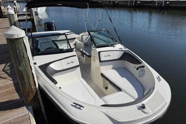 Slide: The Image of 2017 Sea Ray SPX 190 Outboard boat docked, featuring sleek design and spacious seating. - 9